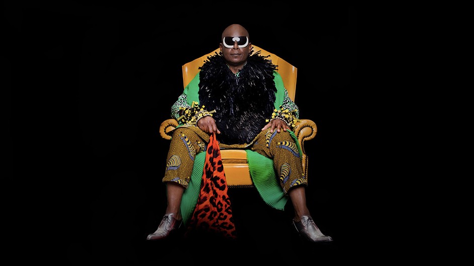 Renee Cox, Beau McCall’s outtake from "The Signing," 2020, Archival pigment print, Courtesy of the artist. An image of a seated man wearing sunglasses against a black background.