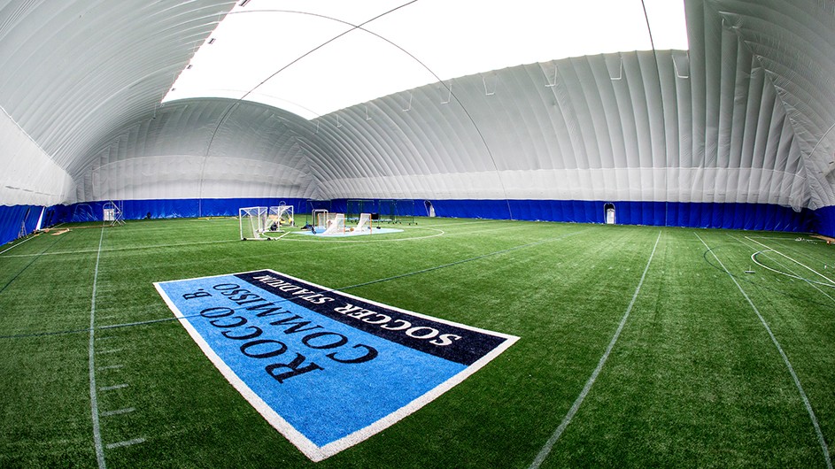 Inside the Bubble at Columbia University’s Baker Athletics Complex: green sports field with goalie nets in the background inside a dome.  