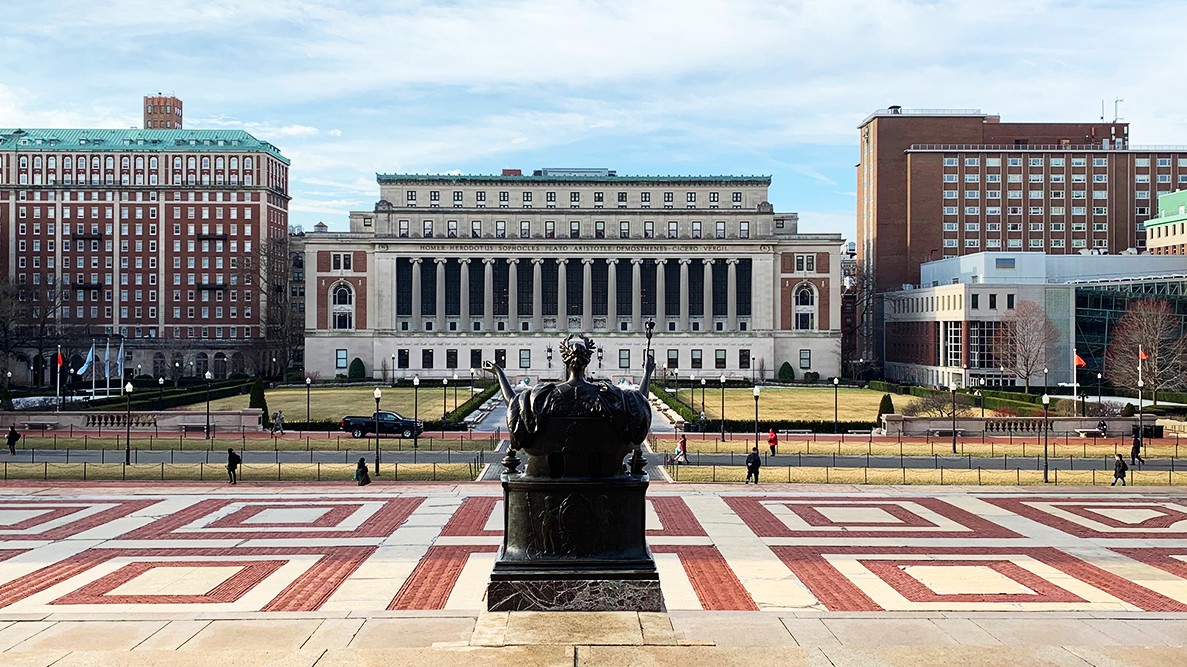 Looking south on Morningside campus with Butler Library in the background and the backside of the Alma Mater statue in the foreground.