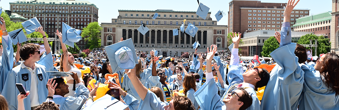 Students throw their mortar boards in the air at Commencement 2023