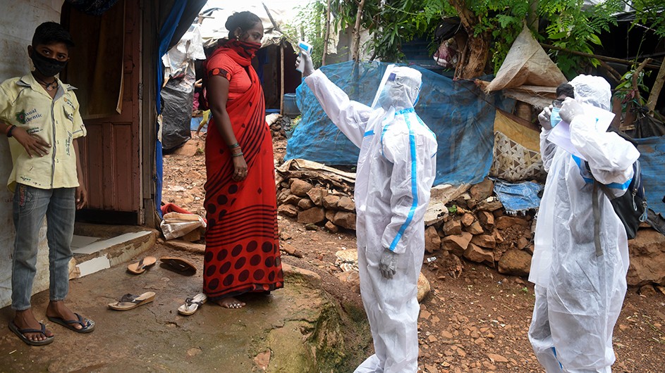 A woman in Mumbai has her temperature checked as part of efforts in India to combat the spread of COVID-19. Covid testing in Mumbai, India. The economies of many developing countries face serious recovery challenges from the pandemic.
