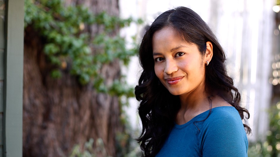 Denise Cruz, a professor in the English and Comparative Literature Department, is thinking more deliberately about course design for online teaching. Photo: Stuart Lawler. Denise Cruz: a woman with long dark hair and a blue shirt.