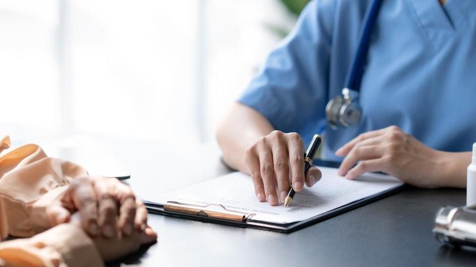 Stock image of a doctor speaking to a patient.