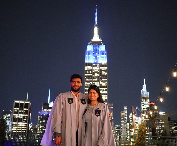 Two students stand in front of the Empire State Building