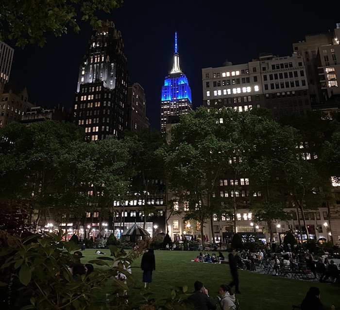 Photo by Florian Hoffmann (GSAS'25). The Empire State Building image ® is a registered trademark of ESRT Empire State Building, L.L.C. and is used with permission. Bryant park view of the Empire State Building.