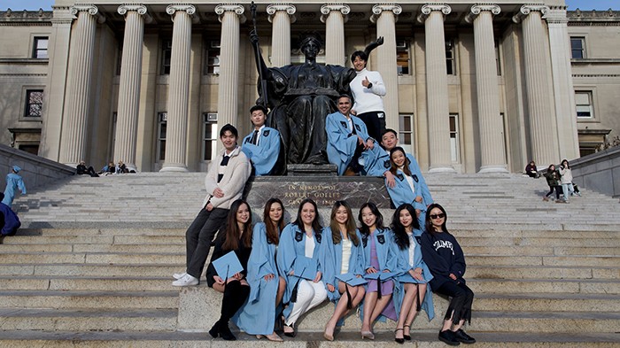 A group of students pose with Alma Mater