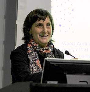GSAPP Professor Laura Kurgan is director of the school's Center for Spatial Research. Laura Kurgan: A woman wearing a colorful scarf speaking at a lectern.