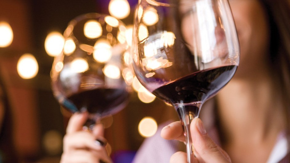 Two wine glasses being toasted