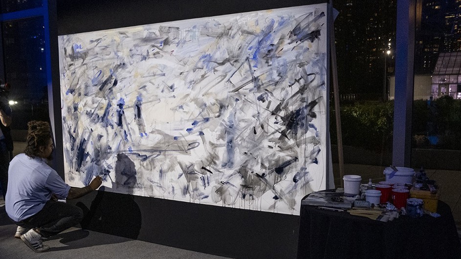 Columbia University student Aristotle Forrester creates a work of art at Obama Foundation event.