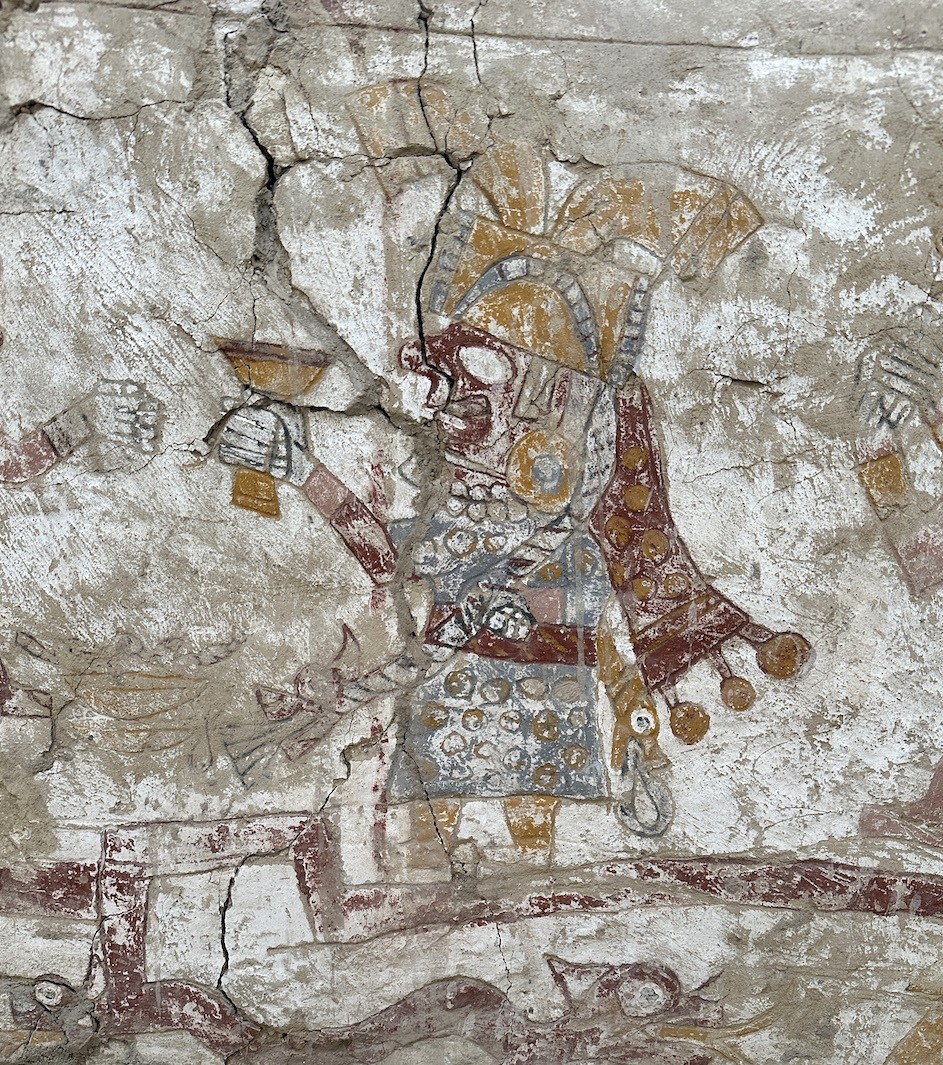 Painting of the crowned woman raising a goblet, on the exterior of the painted throne discovered within the Hall of the Moche Imaginary in 2024. Photograph by Lisa Trever Painting of the crowned woman raising a goblet, on the exterior of the painted throne discovered within the Hall of the Moche Imaginary in 2024. Photograph by Lisa Trever