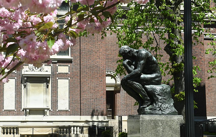 Photo of The Thinker by Eileen Barroso The Thinker sculpture between Magnolia flowers.