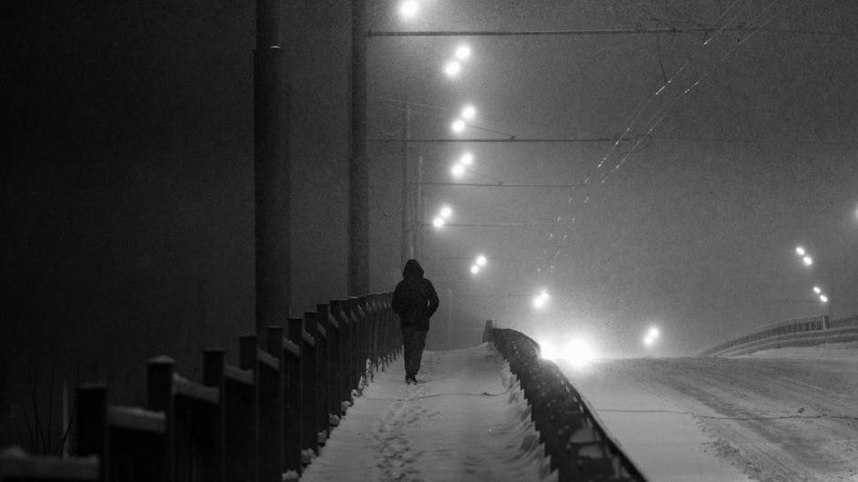 A person walking at night.