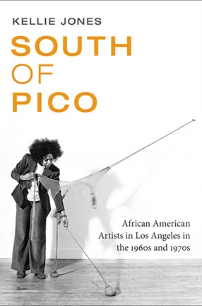 Book cover for South of Pico, featuring a black and white photo of a woman slacks and a blazer installing a piece of art.