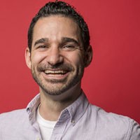 Craig Spencer man in button-down shirt with dark hair, smiling