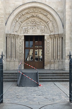 The Basilica of Saint-Denis, north of Paris, with an accessibility ramp, an example of a historic structure that is hard to access for the disabled. The entrance to a church with a carvings around the door.
