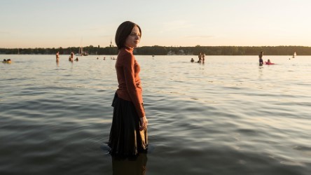 Still from Unorthodox, co-created by Anna Winger '93, image courtesy of 'The New York Times.' Unorthodox: A woman fully clothed standing in the water.