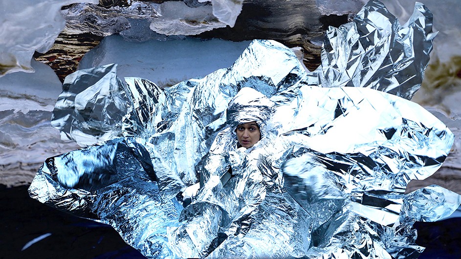 Himali Singh Soin, stills from we are opposite like that (2019). Image courtesy of the artist. An artistic photo image of a woman's face surrounded by what looks like water and silver wrapping paper.