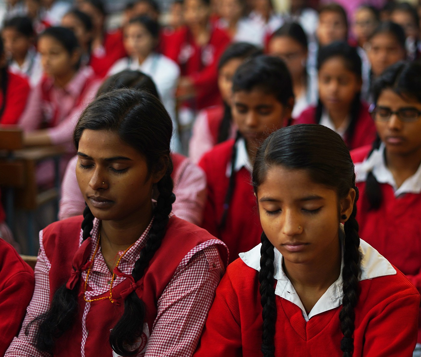 Group of young women dressed in red uniforms at a school in New Delhi.