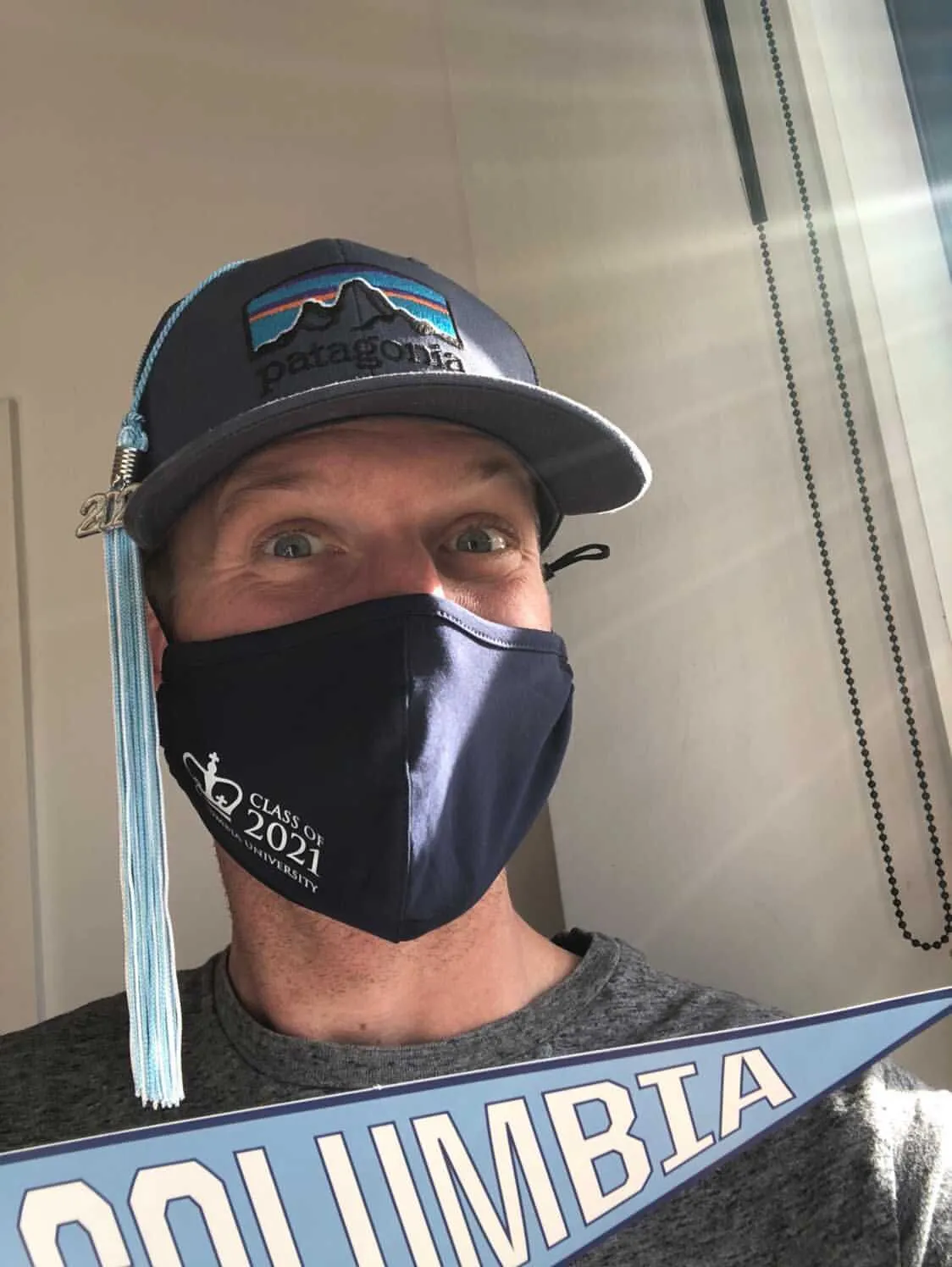 A Columbia grad in a baseball cap with tassel in New Zealand. 
