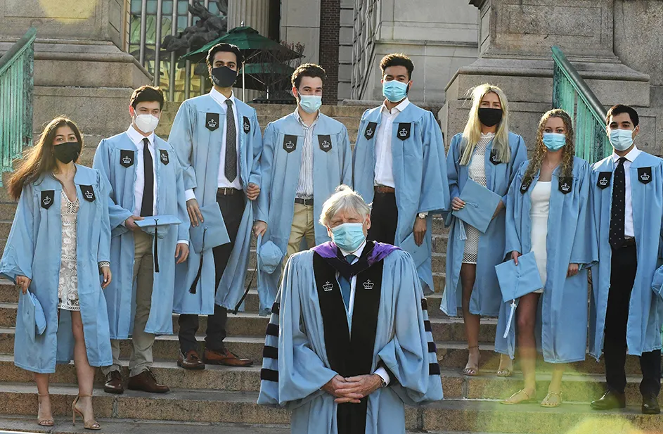 Columbia President Lee Bollinger poses with several grads on Low Steps.