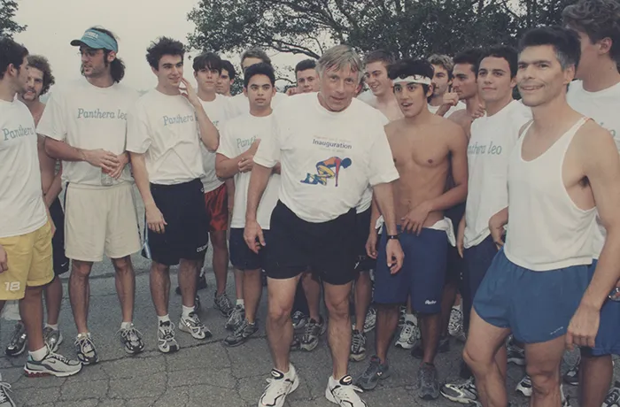 President Bollinger poses with the swim team. 