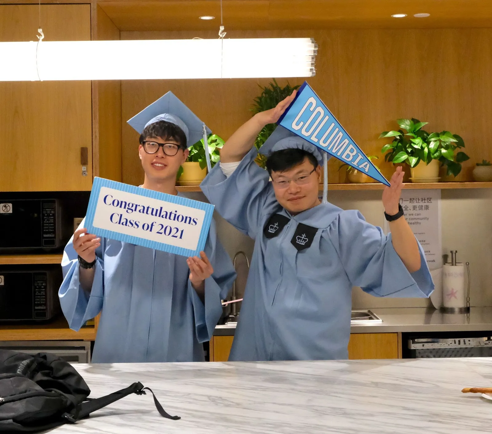 Two grads in Columbia regalia celebrate in Shanghai. 