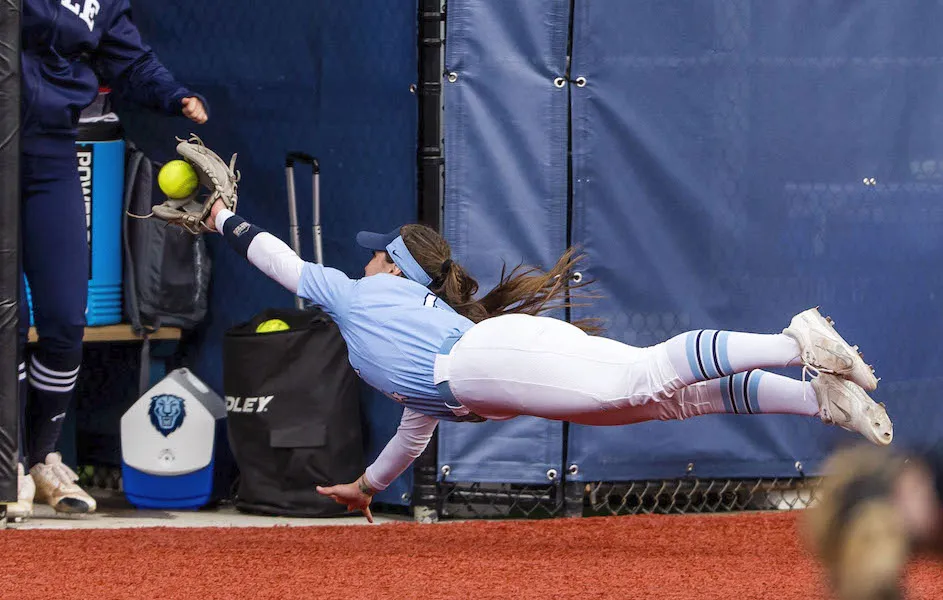 College College undergrad, Bubba Gleaves, dives for a softball at a recent game against Yale.