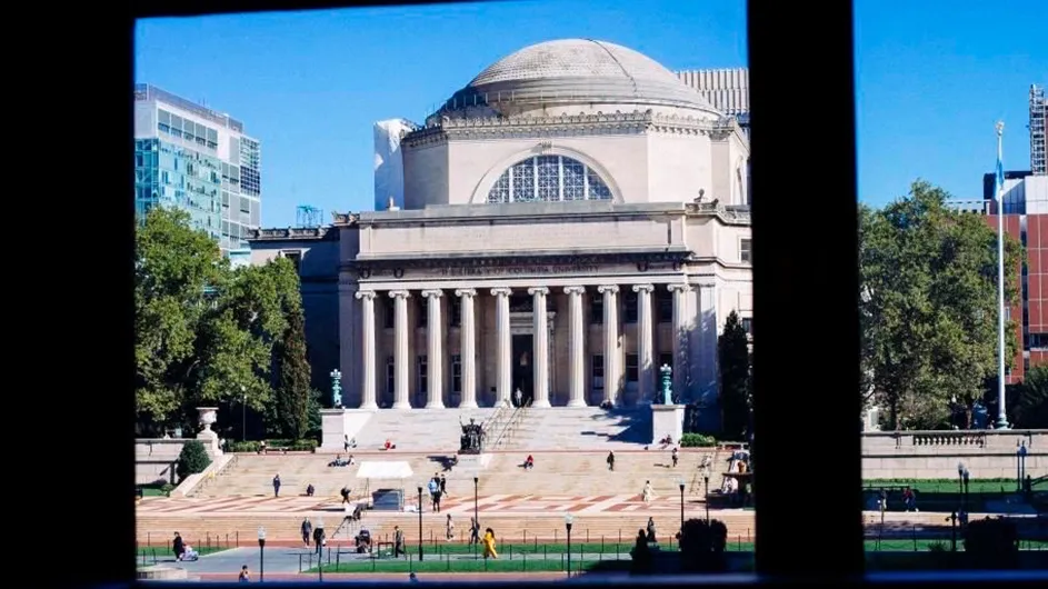 Low Library against a blue sky from inside Butler Library at Columbia University.