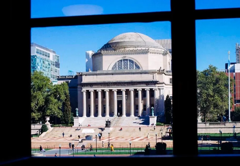 Low Library against a blue sky from inside Butler Library at Columbia University.