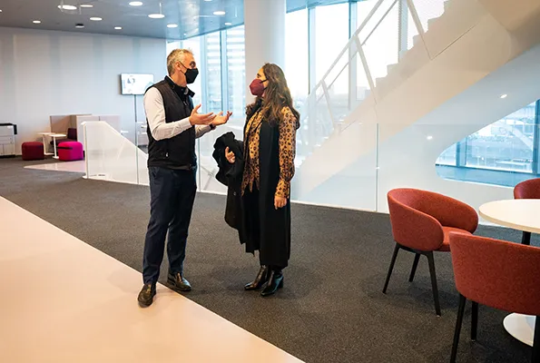 Costis Maglaras speaks with a friend in Columbia Business School. 