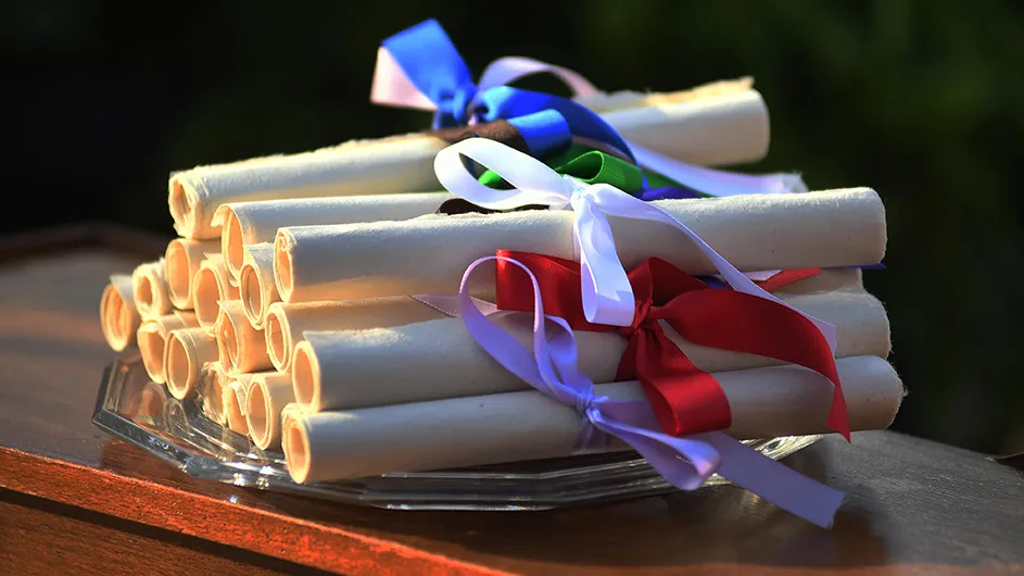 papers rolled up with ribbon