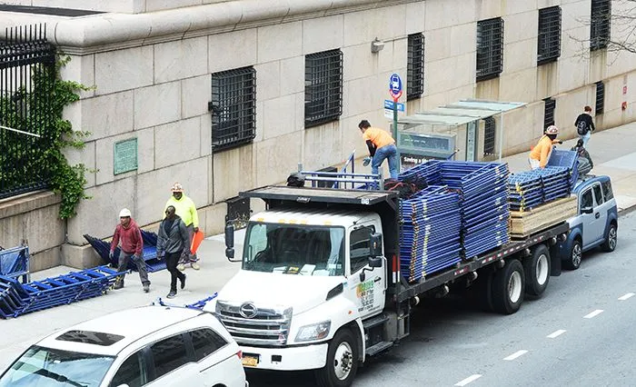 A truck with commencement materials is in front of the Columbia campus. 