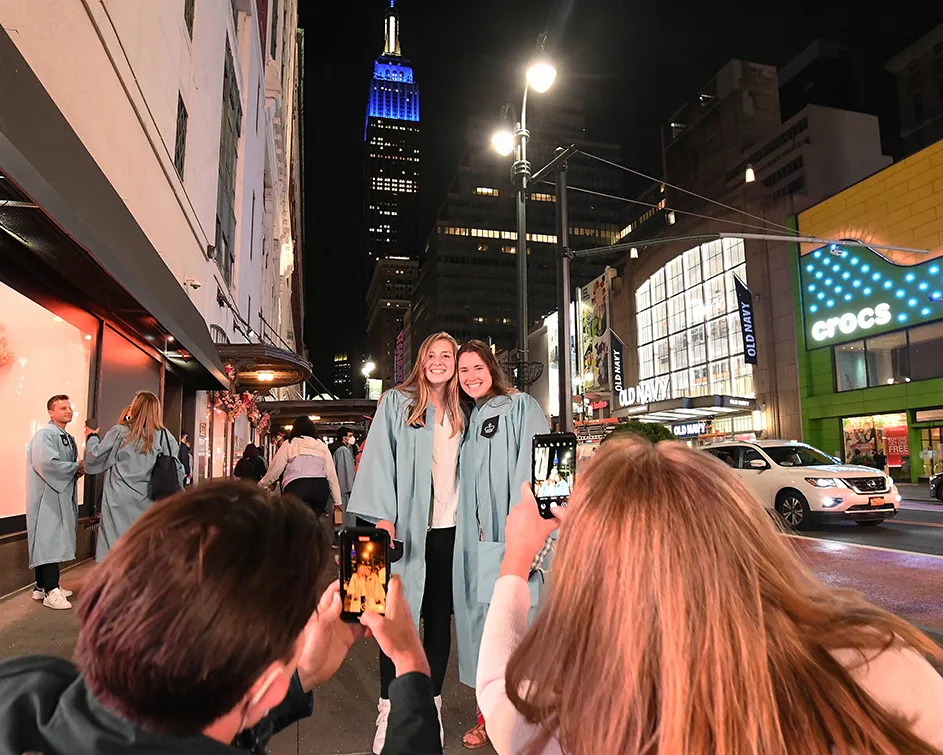 parents take photos of two friends