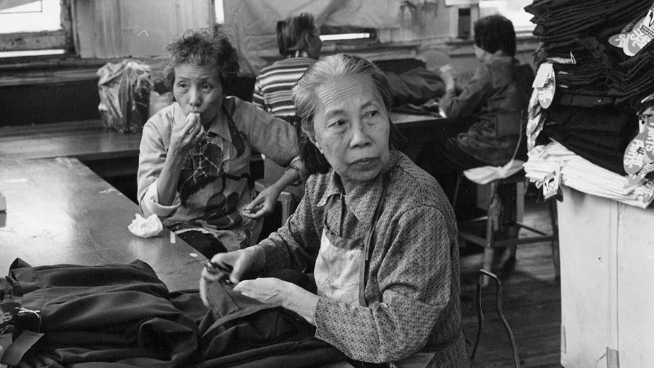 Factory trimmers, 1984; photograph by Paul Calhoun; courtesy of Museum of Chinese in America.