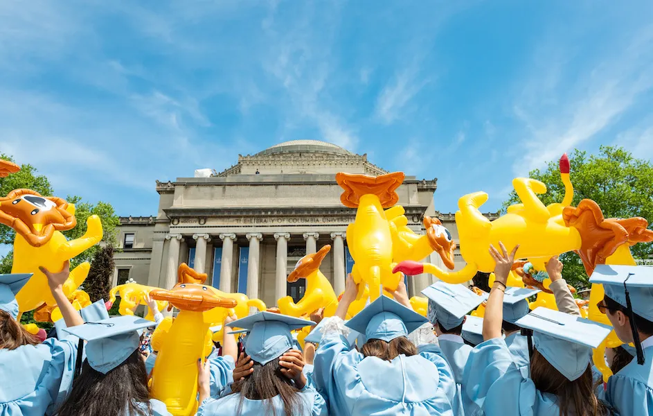 Columbia graduates with inflatable lions over their heads, Columbia University campus