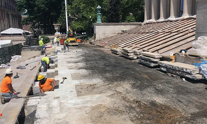Construction workers strip Low Library steps and walkway. 