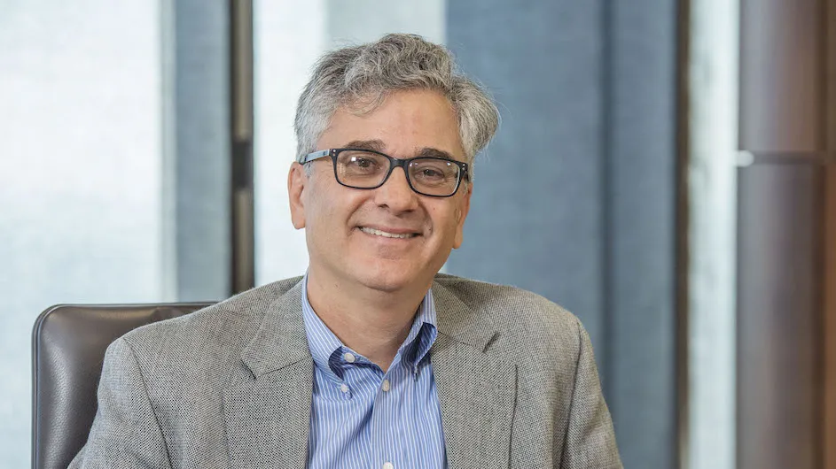 Vincent Schiraldi of Columbia University's School of Social Work, seated wearing a grey blazer and a light blue shirt