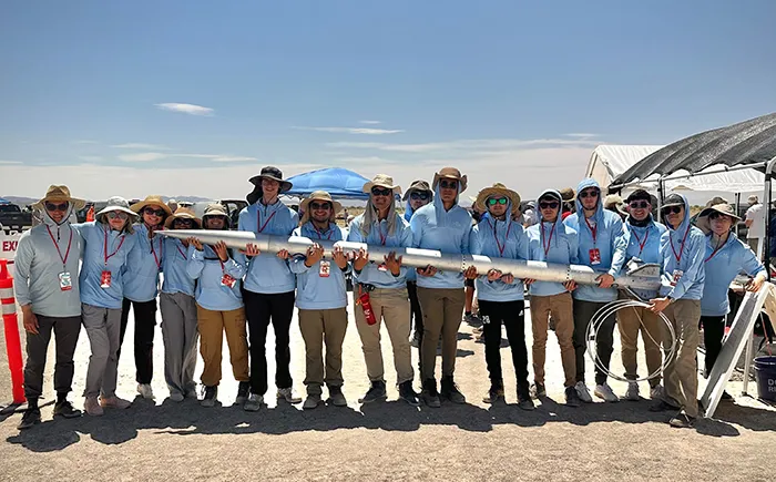 Columbia Space Initiative team holds a rocket to space. 