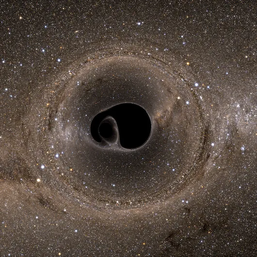 A computer rendering of two black holes that are about to merge, as viewed from the side. (Credit: SXS Lensing/Simulating eXtreme Spacetimes Collaboration)