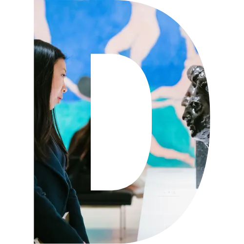 A D block letter with a student at MOMA looking at a sculpture