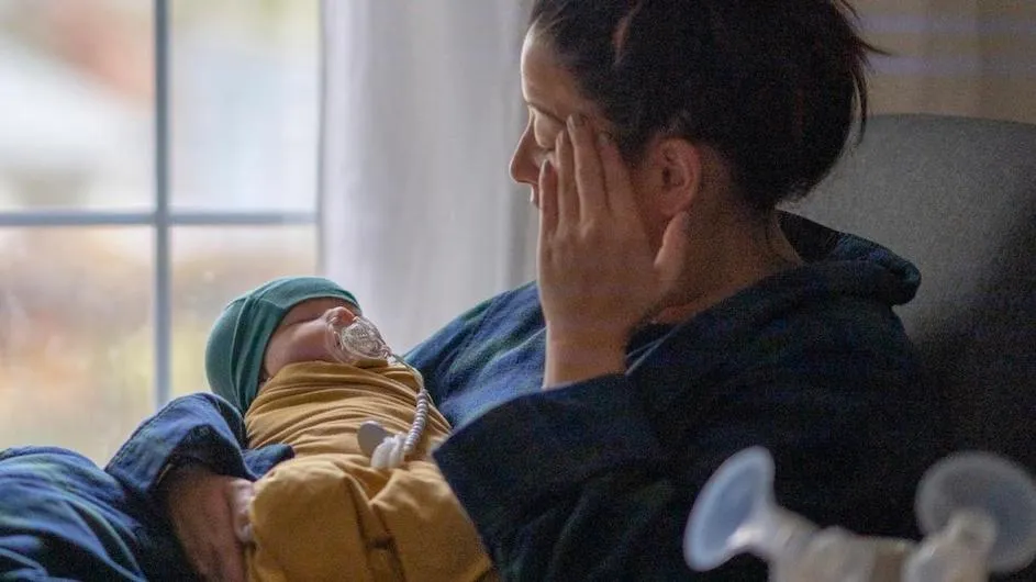 A woman holding a baby.