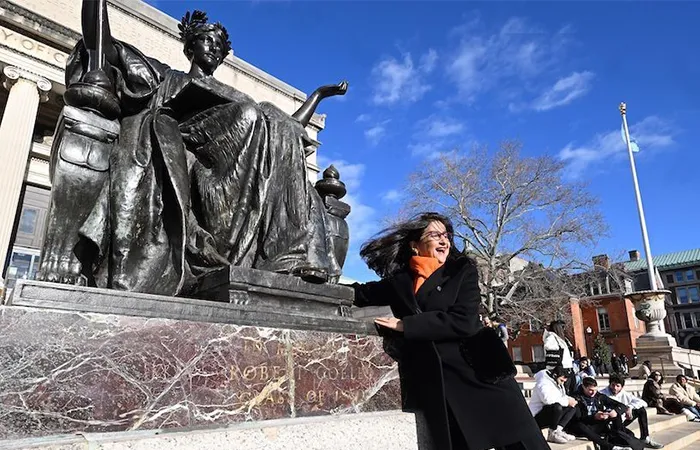 Minouche Shafik searches for the owl in Alma Mater's robes. 