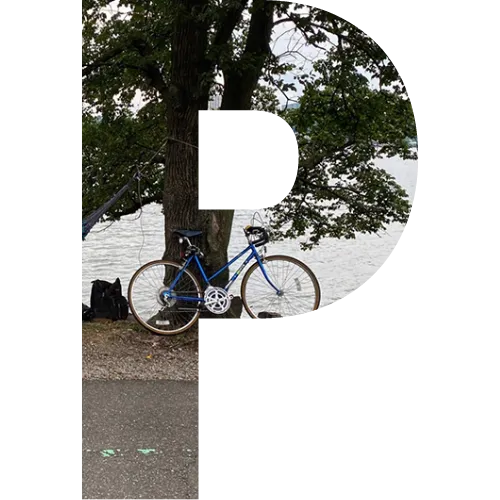A block letter P with a picture of a bike in the middle