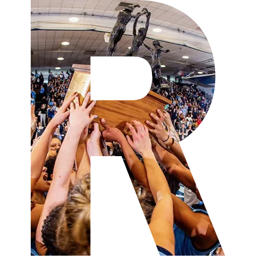 A block letter R with the Columbia women's basketball team holding a championship trophy.