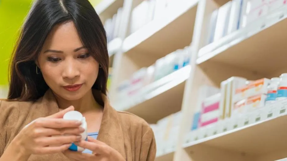 A person looking at a pill bottle.