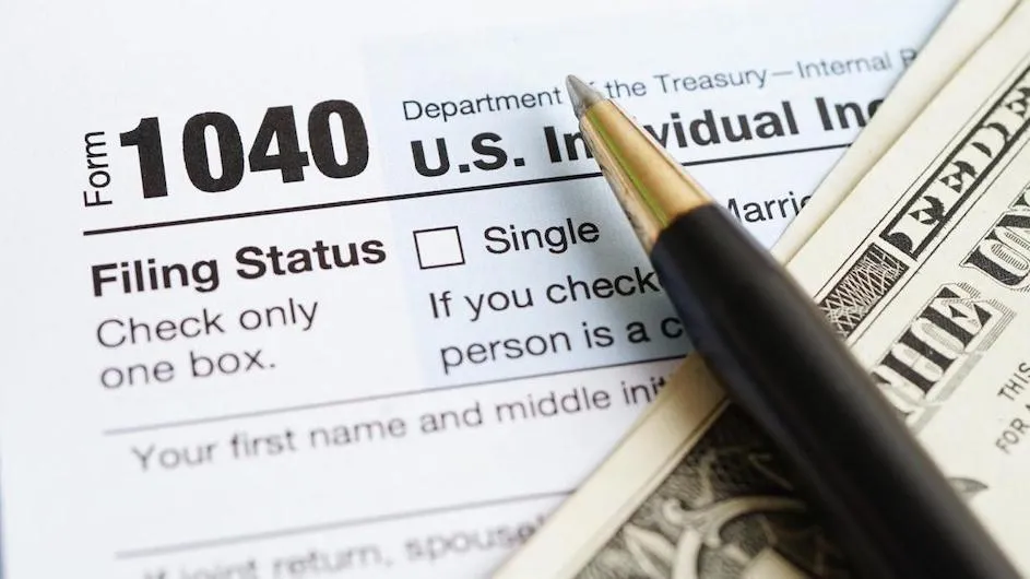 A pen sitting on a tax form.