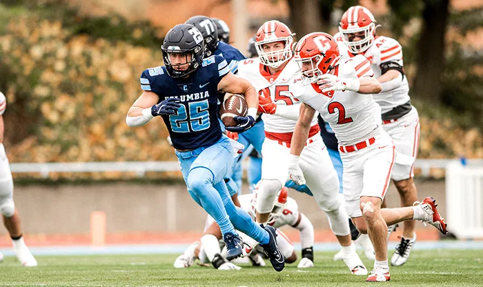 A Columbia players gets ahead of Cornell on the football field 