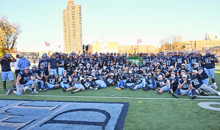 The entire Columbia football team and staff pose for a celebratory photo. 