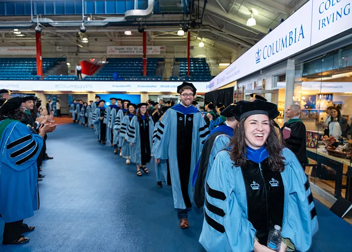 Graduates of the Vagelos College of Physicians Surgeons walk into the Armory. 