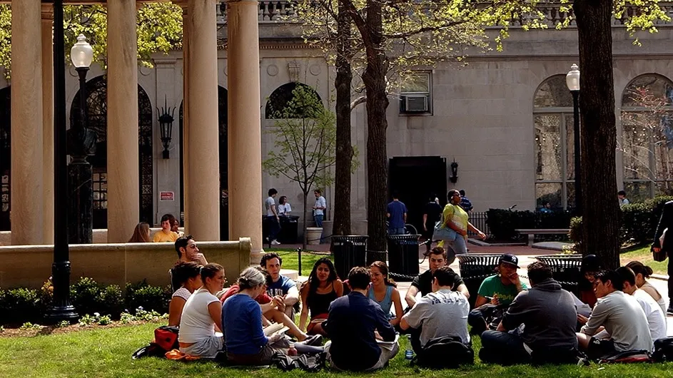 Students sitting on the lawn at Columbia University in a class discussion